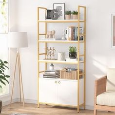 a living room filled with furniture and a white book shelf next to a chair on top of a hard wood floor