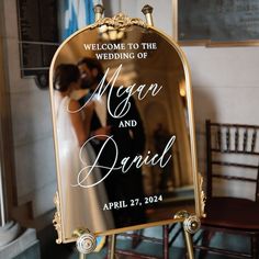 a sign that says welcome to the wedding of morgan and david in front of a mirror