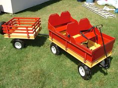 two children's wagons sitting in the grass