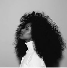 a black and white photo of a woman with curly hair