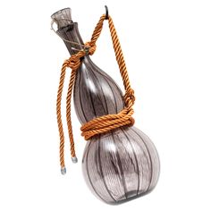 a glass vase with rope wrapped around it on a white background, in the shape of an onion