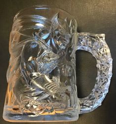 a glass mug with a skeleton on it