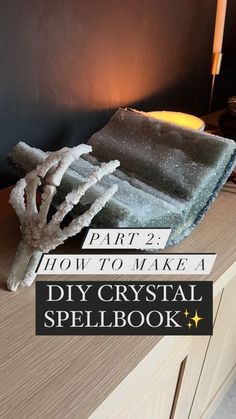 a crystal spell book on top of a wooden table