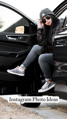 a woman sitting in the door of a car