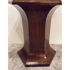 a large wooden table sitting on top of a marble floor