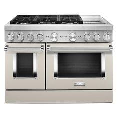 a stainless steel stove with two ovens on each side and four burners in the middle