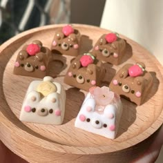 a wooden tray with chocolates shaped like teddy bears on it's sides and some smaller ones in the middle