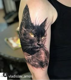 a woman with a cat tattoo on her arm and the other arm is showing it's face