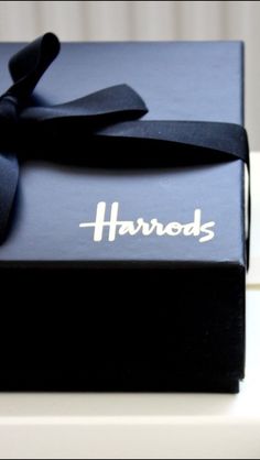 two black and white boxes with ribbons on them