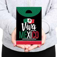 a person holding a sign that says viva mexico