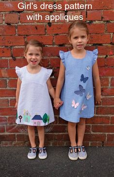 Girls a-line dress sewing pattern with two applique designs. A simple easy to sew a-line dress pattern for girls in 7 sizes. Optional applique designs can be added. Lovely frill sleeves. #StyleArc #GirlsAppliqueDressPattern #GirlsDressPattern #EasySewingPattern #QuickSewingPattern #SewingForGirls #EasyDressPattern #SimpleDressPattern #EasyGirlsDressPattern #CuteDressPattern #DressSewingPattern Easy Girls Dress, Frocks For Kids, Style Arc, Girls Applique, Kids Dress Wear, Kids Dress Patterns