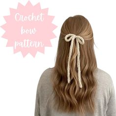 the back of a woman's head with long hair tied in a bow