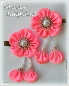 three pink flowers with pearls on them