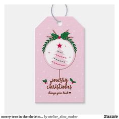 a pink christmas ornament with a tree on it