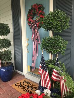 a patriotic wreath on the front door of a house