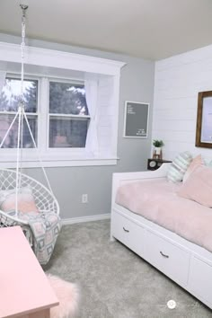 a bedroom with a hammock chair and window