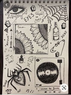 a notebook with drawings on it and an image of a sunflower, spider, and eye