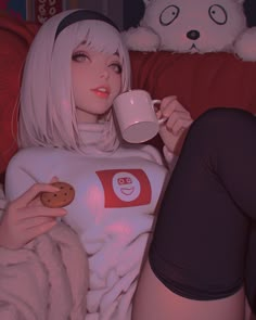 a woman with white hair is holding a cookie and a mug while sitting on a couch