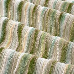 several rows of green and white knitted blankets