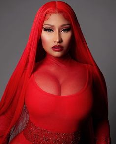 a woman with long red hair wearing a red dress