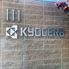 the sign for kyocera is displayed on a wall