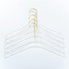 a set of five clear hangers with gold pins