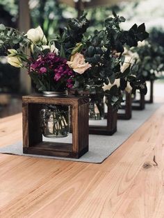 some flowers are sitting in small vases on a table