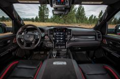 the interior of a vehicle with black leather and red stitching on the dash board