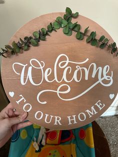 a wooden sign that says welcome to our home