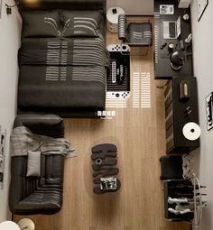 an overhead view of a living room with black furniture and accessories on the wood floor