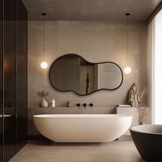 a bathroom with a large oval mirror above the bathtub