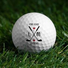 a white golf ball with the words fore - eyed l m on it sitting in grass