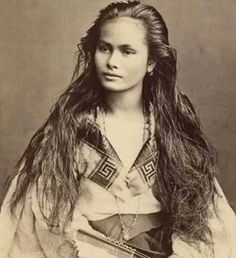 an old photo of a woman with long hair