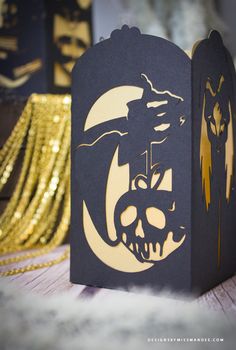 a black and gold halloween treat box with an image of a demon on it's face