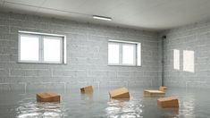 some boxes floating in the water near two windows