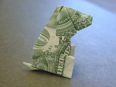 an origami bear made out of one dollar bill