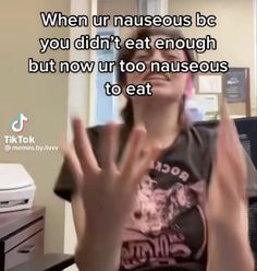 a woman sitting in front of a desk with her hand up to the camera and saying, when urn nauseous be you didn't eat enough but now