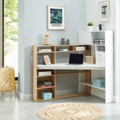 a computer desk with shelves and drawers in a room