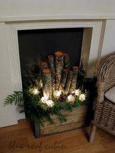 a fireplace decorated with logs and christmas lights