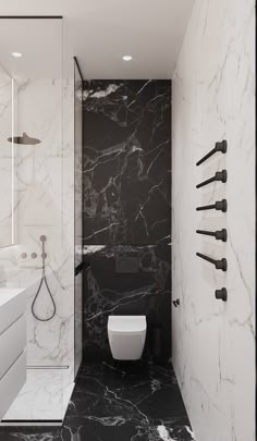 a white toilet sitting next to a walk in shower under a faucet mounted on the side of a wall