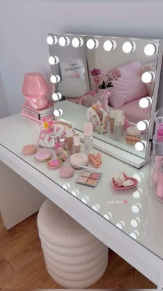 a vanity with lights and cosmetics on it