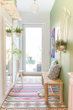 a hallway with a bench, potted plants and other decorations on the wall next to it