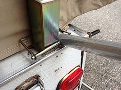 a man standing next to a metal object