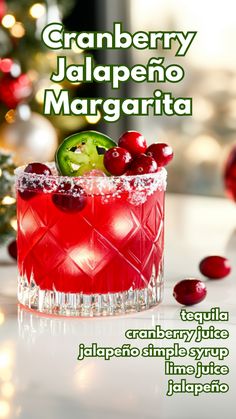 a red cocktail with cranberry jalapeno margarita on the rim and garnishes