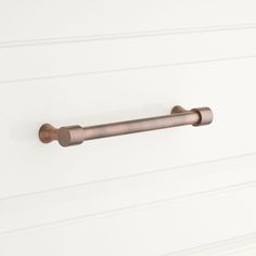 a close up of a metal handle on a white wall