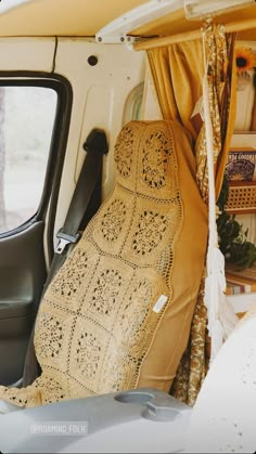 the interior of an old van with crocheted seat covers