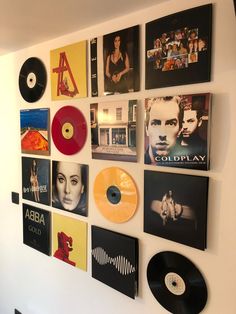 the wall is covered with various records and cds, including one that has been placed on it