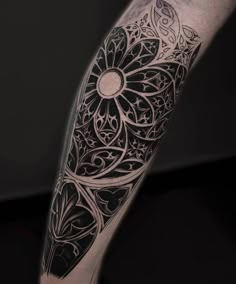 a man's arm with an intricate tattoo design on it, in black and white