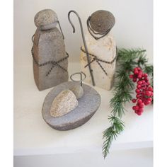 two stone salt and pepper shakers sitting on top of a white counter next to berries