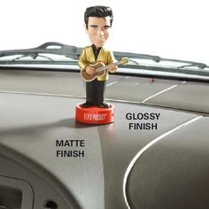 a bobble head figure sitting on top of a car dashboard with the words gloss finish and glossy finish